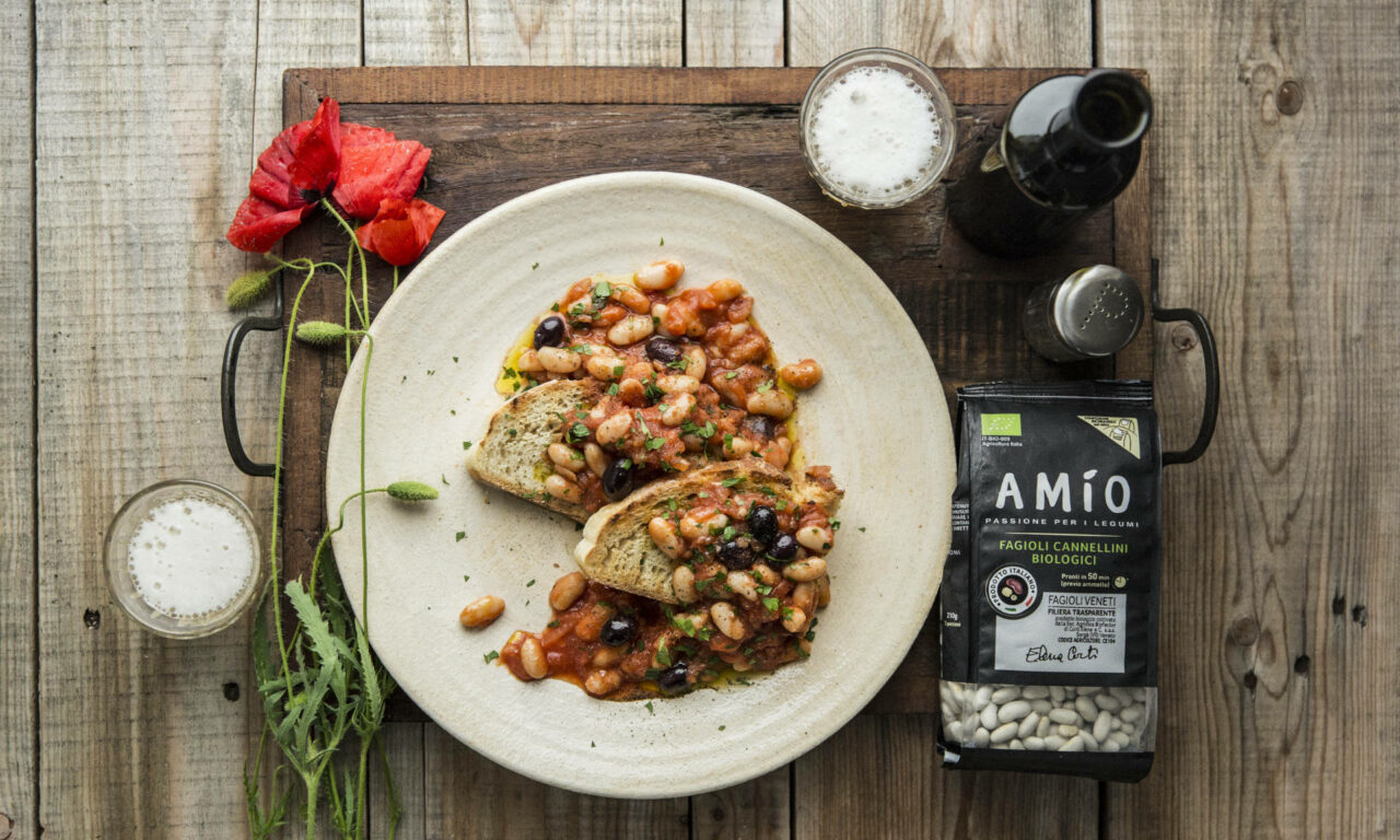 Crusty bread topped with creamy cannellini beans, juicy tomatoes, and savory black olives