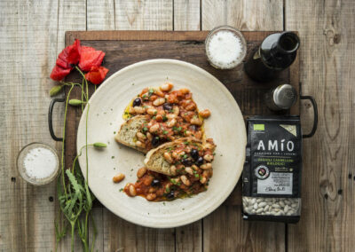 Crusty bread topped with creamy cannellini beans, juicy tomatoes, and savory black olives
